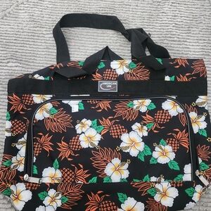 American Uni tropical print travel tote bag featuring a black background with a